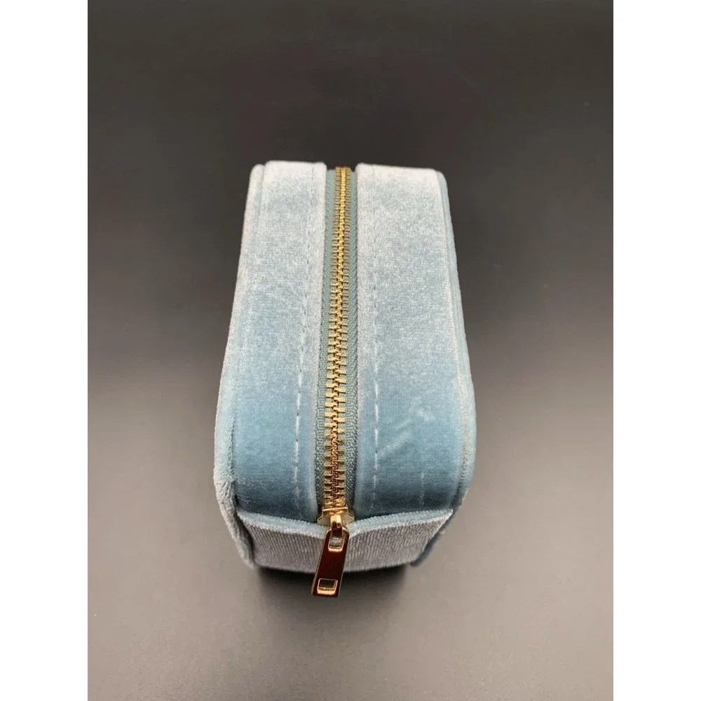 Small blue velvet jewelry box with a zipper